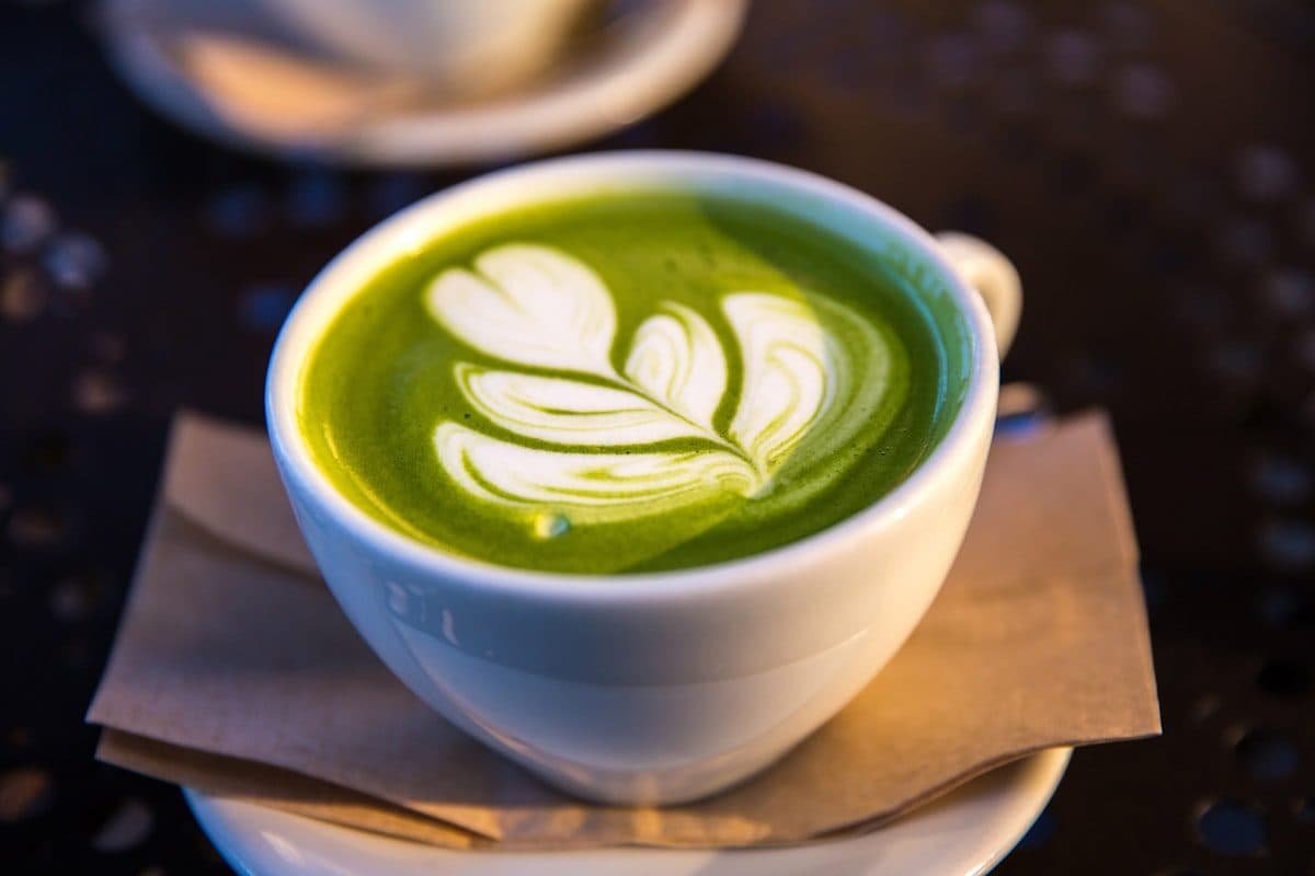A creamy green Moringa latte in a cup